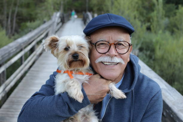 istock Tender senior man and his small dog 1359359840