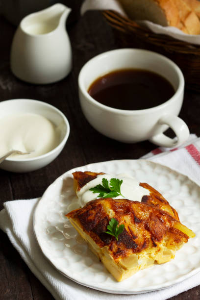 istock Traditional Spanish or Italian omelet with potatoes, served with coffee. Rustic style. 1359359954