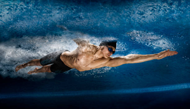istock Man in swimming pool. View underwater 1359362730