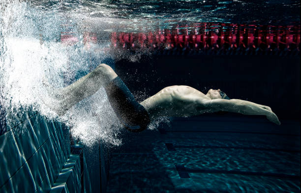 istock Professional male swimmer in action inside swimming pool 1359362737