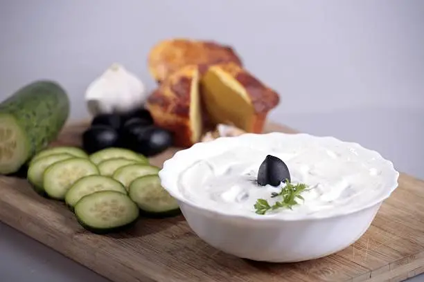 yoghurt and cucumber on the wooden board