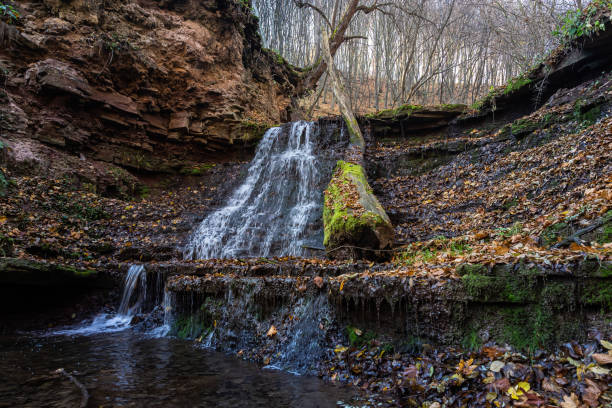 istock Tranquil waterfall scenery in the middle of autumn forest 1359365062