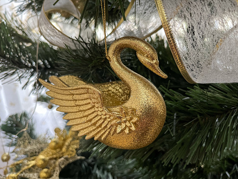 Christmas toy for the Christmas tree in the form of a golden swan.