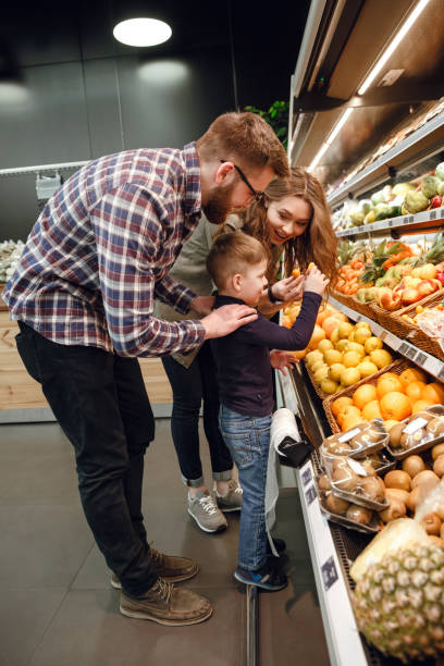 istock Vertical image of family playing with citrus 1359367579