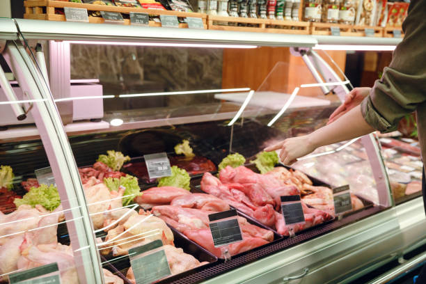 istock Cropped image of couple choosing meats 1359368093