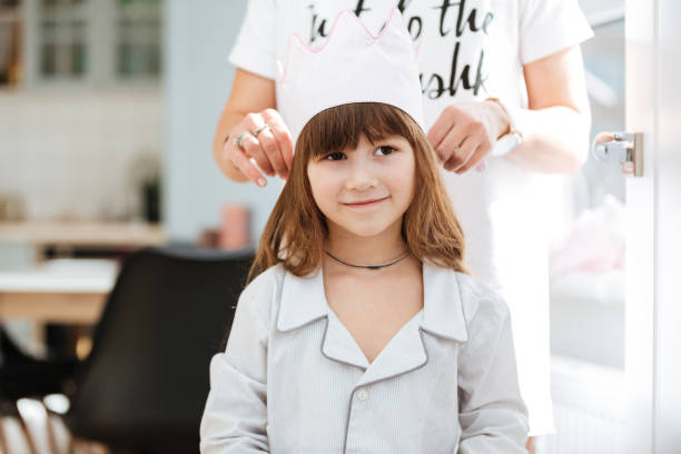 istock Mother wearing her girl crown 1359370866