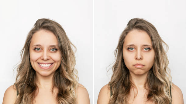 Two portraits of young caucasian blonde woman with positive and negative emotions cheerful and sad Two portraits of a young caucasian beautiful blonde woman with wavy hair: cheerful and sad isolated on a white background. Before and after. A smile affects appearance. Negative and positive emotions sadness stock pictures, royalty-free photos & images