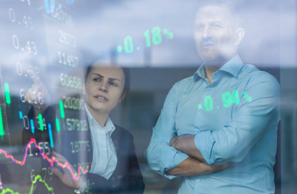 istock Busines couple watching stock market data on a modern interface 1359372077