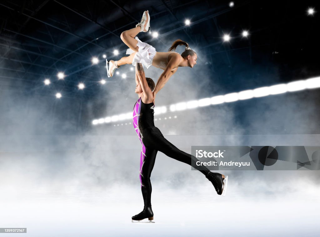 Duo figure skating in action on dark background Duo figure skating in action on dark background. Sports banner. Horizontal copy space background Figure Skating Stock Photo