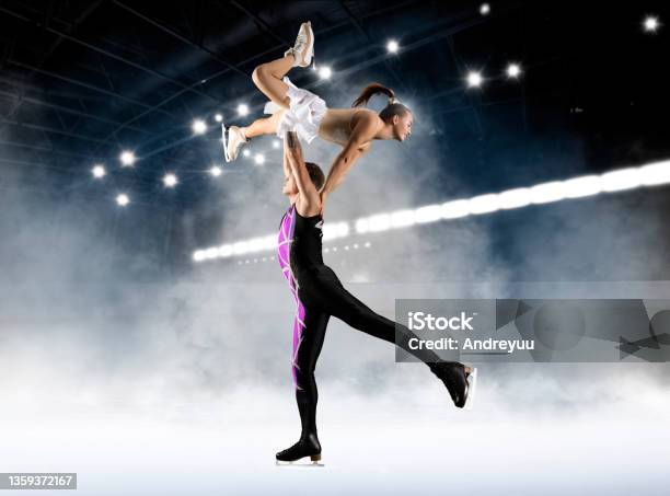 Duo Figure Skating In Action On Dark Background Stock Photo - Download Image Now - Figure Skating, Jumping, Couple - Relationship