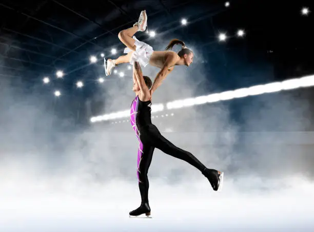 Duo figure skating in action on dark background. Sports banner. Horizontal copy space background