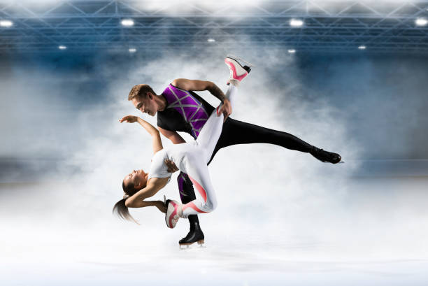 istock Duo figure skating in action on dark background 1359372177