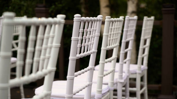 istock White plastic Chiavari chairs in rows. Outdoor wedding ceremony 1359373048