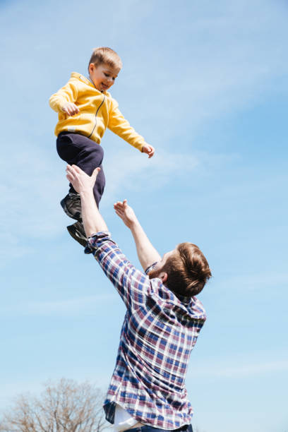 istock Handsome bearded father playing with his little son 1359373093