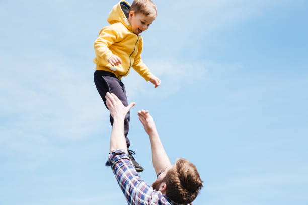 istock Father and his son playing together in a city park 1359373211