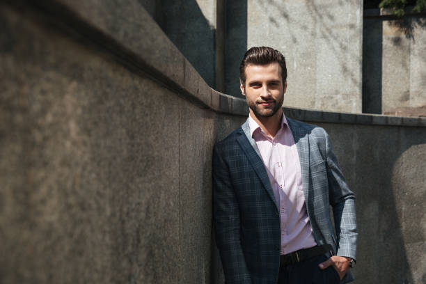 istock Smiling young businessman walking outdoors 1359374047