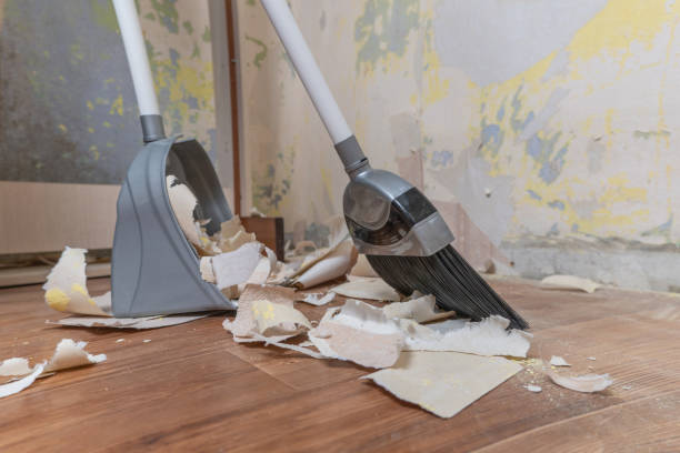istock Clean up garbage after repairs.Sweep up construction debris with a brush in a dustpan.Sweeping at home.Tools for cleaning the house.Make home repairs.The dust.Wall repair.Torn wallpaper from the wall 1359374676