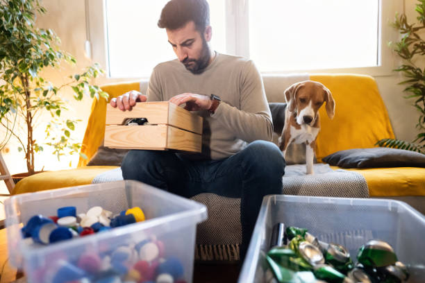istock Caucasian man sort out the cans from the bottle caps for recycling 1359376002
