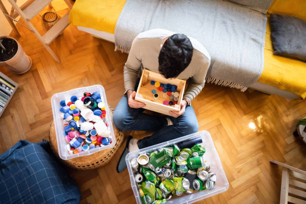 istock Unrecognizable man at his home sort out the waste for recycling 1359376046