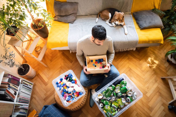 istock Responsible male environmentalist, sort out the waste for recycling at his home 1359376049