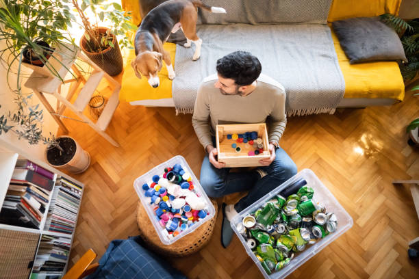 istock Caring male environmentalist, at home, separate the waste for recycling 1359376053