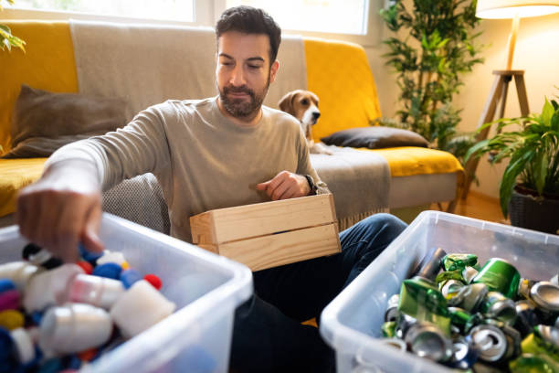 istock Caucasian male environmentalist separate the cans from plastic for recycling 1359376064
