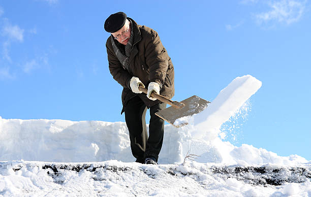 istock Man shovelling snow from a roof 135937611