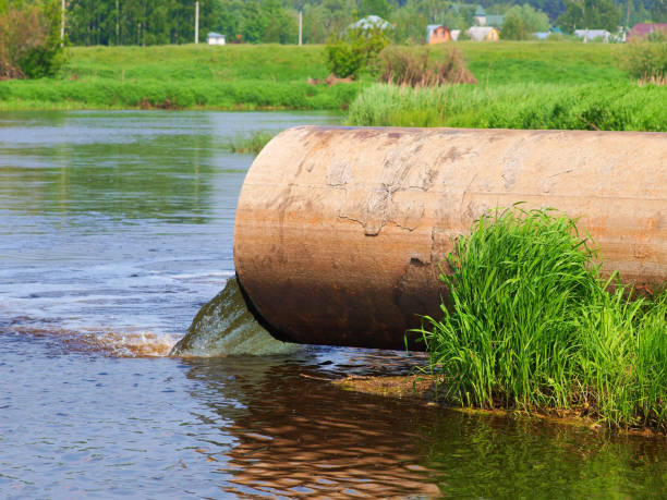 istock Discharge of pollution from the pipe into the river. 1359377052