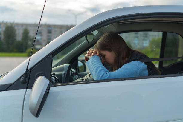 istock Broken off side rearview mirror on car. Driver woman sad after accident 1359377392