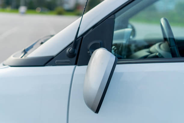istock Broken off side rearview mirror on car. White automobile on road after accident 1359378090