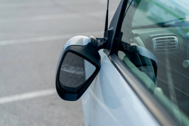istock Broken off side rearview mirror on car. White automobile on road after accident 1359378350