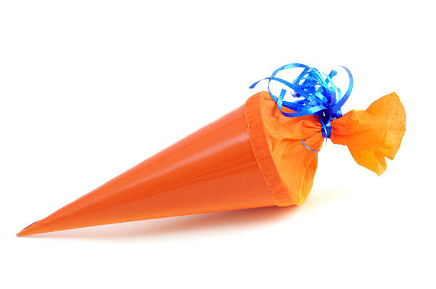 orange Conical bag of sweets orange Schultuete zur Einschulung - Conical bag of sweets zuckertüte stock pictures, royalty-free photos & images