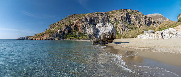 Stunning Preveli Beach, a secluded white sand beach surrounded by palm groves at the end of a gorge where the Megas river encounters the Libyan sea, Crete, Greece