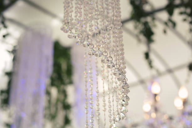 istock Beautiful luxurious romantic decor for a wedding celebration.  The arch is decorated with draped fabric and a crystal chandelier. 1359381162