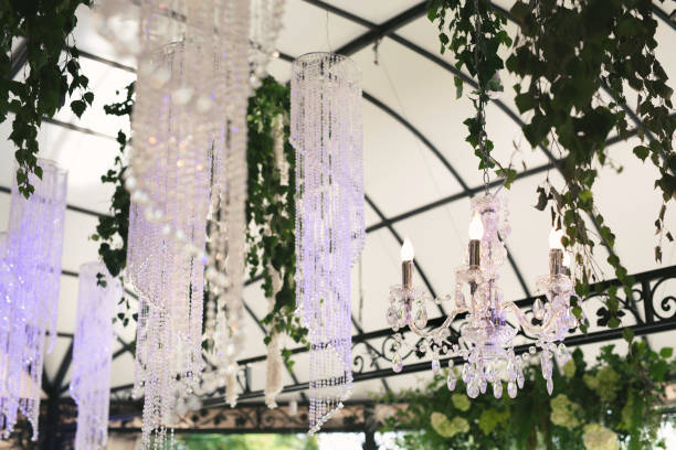 istock Beautiful luxurious romantic decor for a wedding celebration.  The arch is decorated with draped fabric and a crystal chandelier. 1359381337