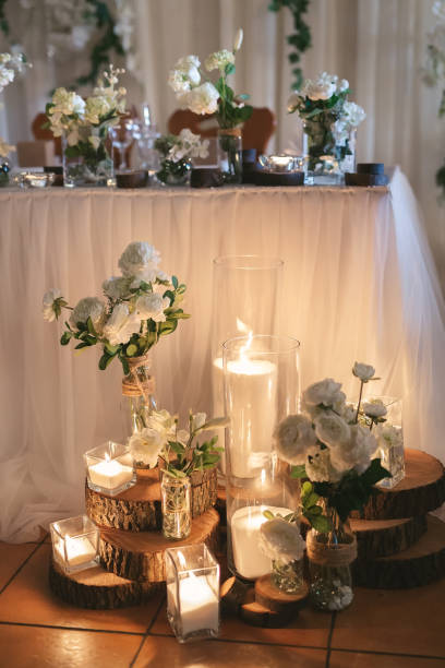 istock Lighted candles placed on wooden logs - Natural and romantic wedding ceremony decoration 1359382332