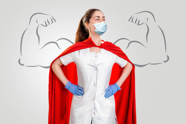 A doctor or nurse in a surgical face mask, gloves, and a superhero Cape. Medical personnel during a coronavirus outbreak. Drawn strong hands. Super hero power for clinic and hospital personal A doctor or nurse in a surgical face mask, gloves, and a superhero Cape. Medical personnel during a coronavirus outbreak. Drawn strong hands. Super hero power for clinic and hospital personal. professional thank you stock pictures, royalty-free photos & images