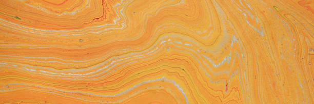 istock orange and gold marbled  paper background 1359383627