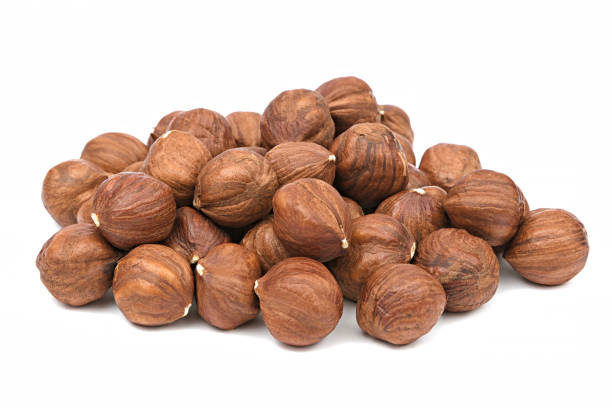Hazelnut unpeeled isolated white background. Pile of hazelnut closeup. Nuts collection stock photo