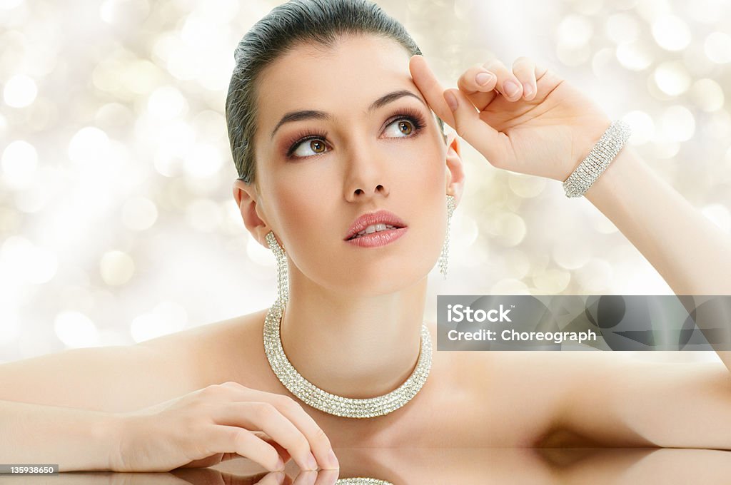 Portrait of a beautiful young woman wearing diamond jewelry portrait of beautiful woman with jewelry Jewelry Stock Photo