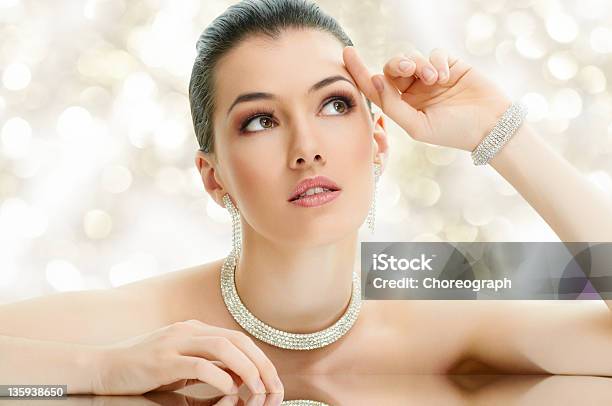 Portrait Of A Beautiful Young Woman Wearing Diamond Jewelry Stock Photo - Download Image Now