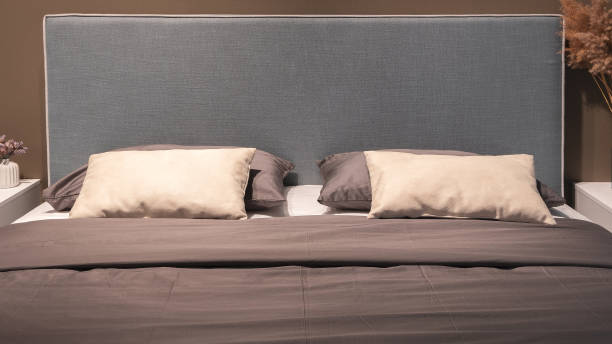istock Big comfortable bed in hotel room 1359386714