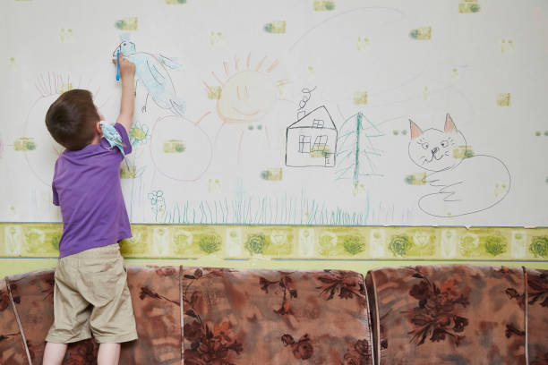 istock 5 years old boy draws on the wall in the room 1359387904