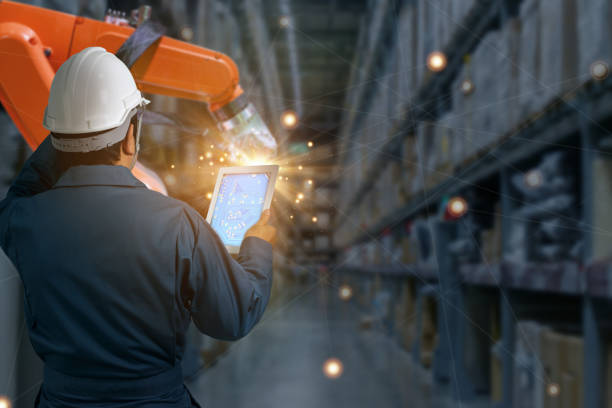 istock Logistics and transportation.,Engineer check and control automation robot arms machine in modern warehouse industrial on real time monitoring system software. product inspection robotics. 1359388568