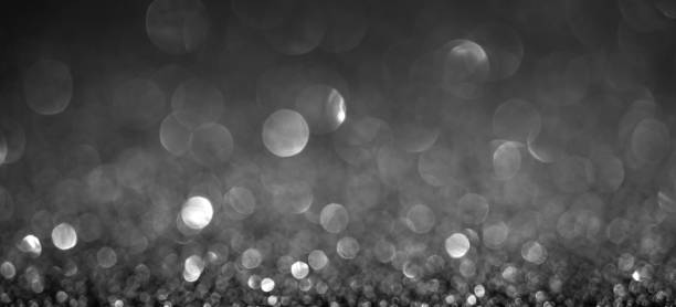 istock Black Christmas lights background, banner design. Shiny glowing surface with bokeh, abstract defocused glitter with sparkles 1359390754