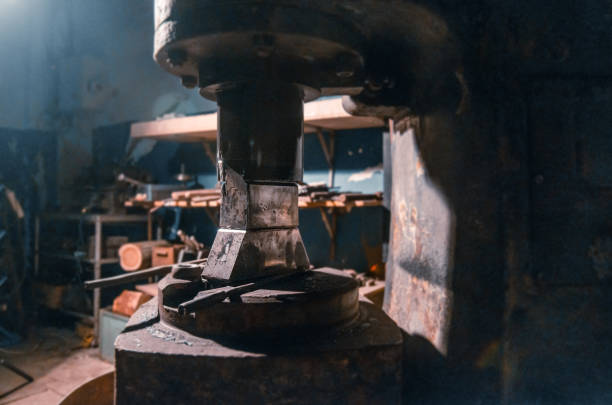 General view of an old percussion machine for forging various metals in a working blacksmith shop without people.