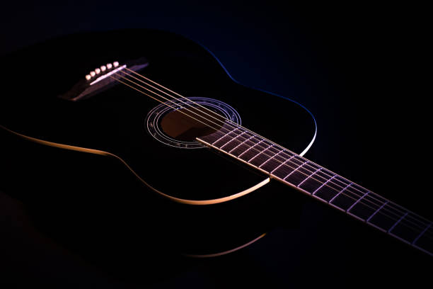 istock black guitar against a dark background. guitar music low-key concept 1359393322