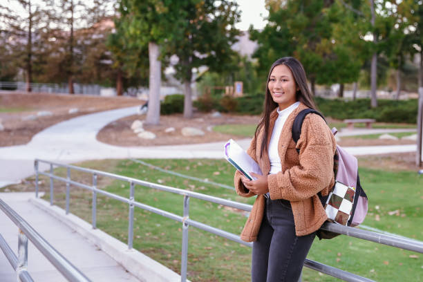istock Teenage female student walking on campus 1359393956