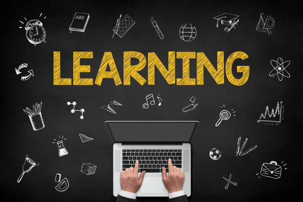 istock Learning concept with businessman working on laptop over blackboard 1359397087