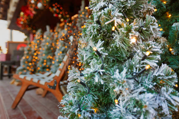 istock New Year's or Christmas background with light bulbs and trees. Bokeh or blur background 1359397308